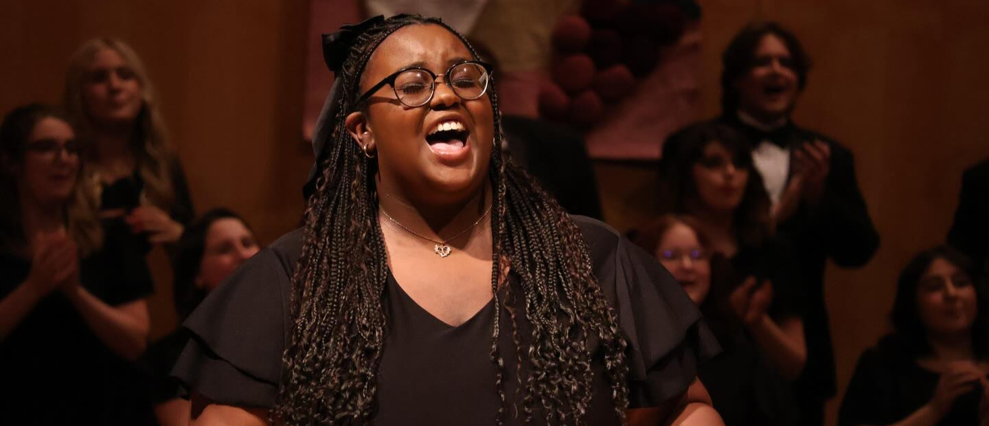 A woman singing on stage