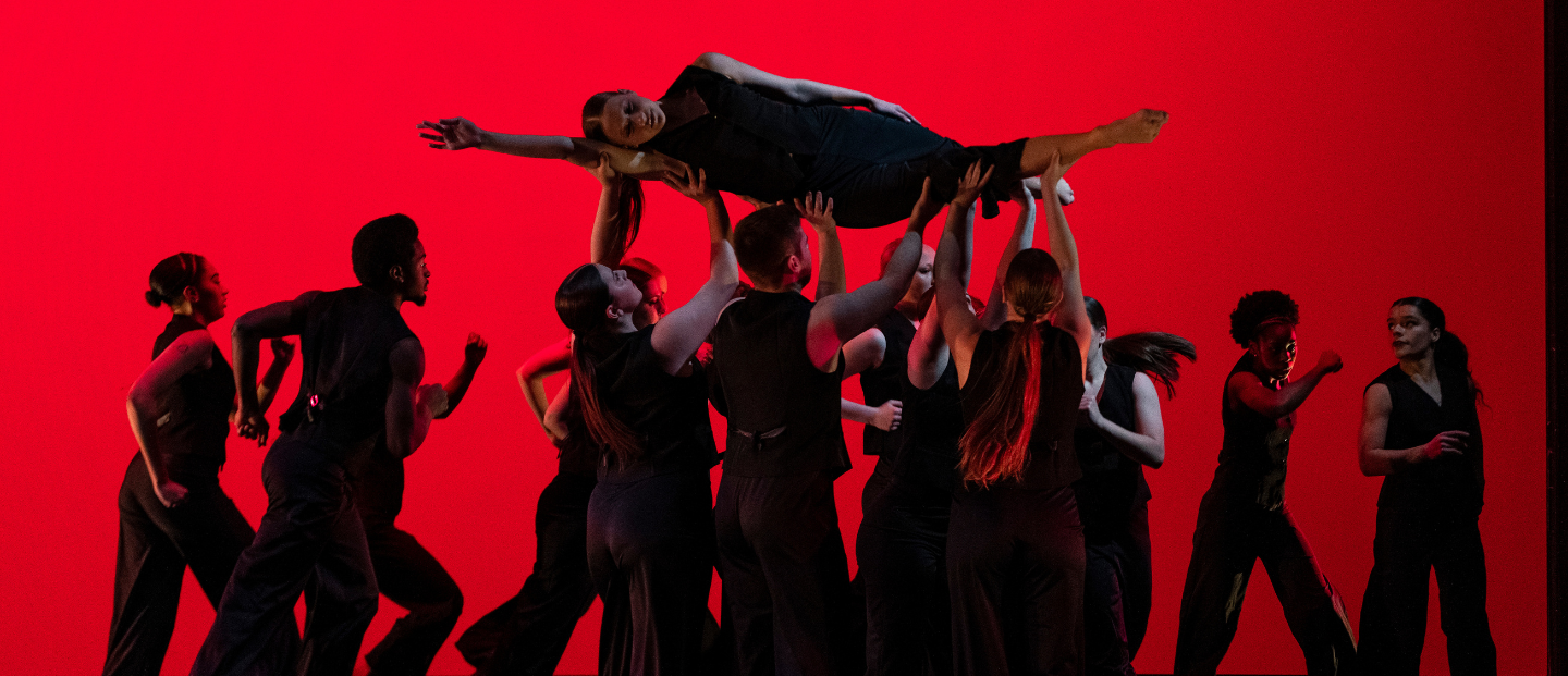 A dance ensemble performing on stage