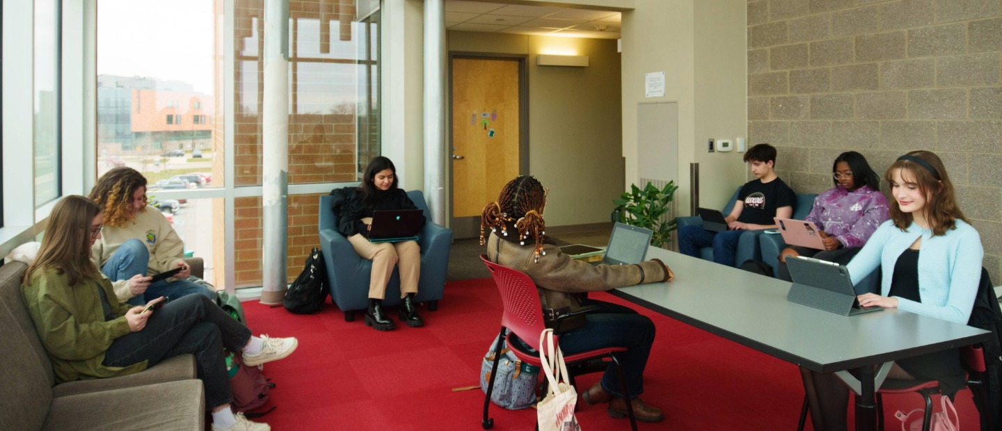 A group of Oakland University students studying together in a common area