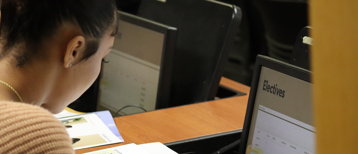 An Oakland University student looking at an Electives web page